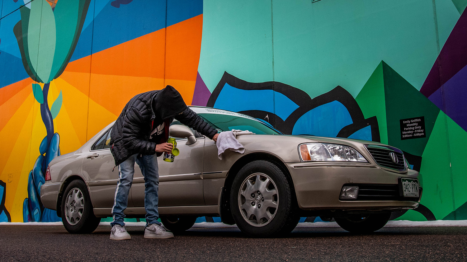 Man waxing a car to be donated to the Troops Relief Fund in Brooklyn
