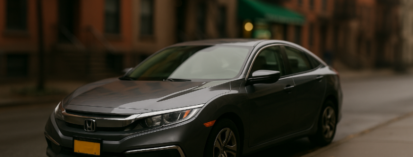 Gray Honda Civic parked on a NYC street, illustrating Staten Island car donation with Troops Relief Fund.