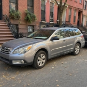 Car on a Brooklyn Rowhouse Block A parked car along a Brooklyn block of brick rowhouses and stoops