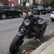 Motorcycle donation questions in Brooklyn A motorcycle parked beside a brownstone stoop on a Brooklyn residential street.