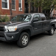 Truck donation details in Brooklyn Pickup truck parked on a Brooklyn street near brick residential buildings