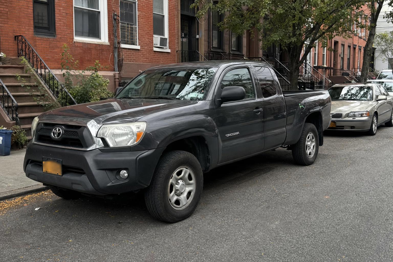 Pickup truck parked on a Brooklyn street near brick residential buildings