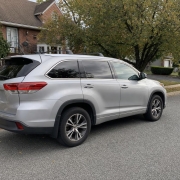 SUV on a Staten Island Residential Street Silver SUV parked on a residential street in front of homes and mature trees on Staten Island
