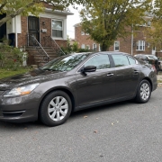Parked car on a tree-lined residential street on Staten Island