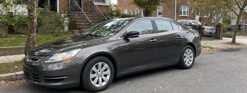 Parked car on a tree-lined residential street on Staten Island