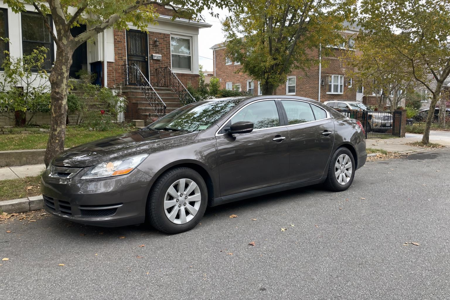 Parked car on a tree-lined residential street on Staten Island