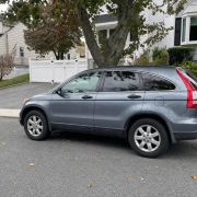 SUV on a Staten Island residential street SUV parked on a tree-lined residential street on Staten Island