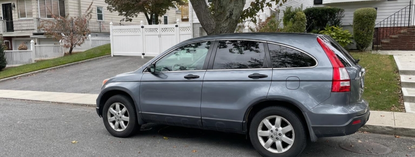 SUV parked on a tree-lined residential street on Staten Island