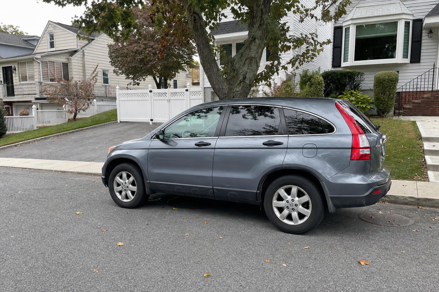 SUV parked on a tree-lined residential street on Staten Island
