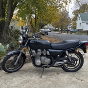 Motorcycle in a Staten Island Residential Driveway Older motorcycle parked in a Staten Island driveway near detached homes and mature trees.